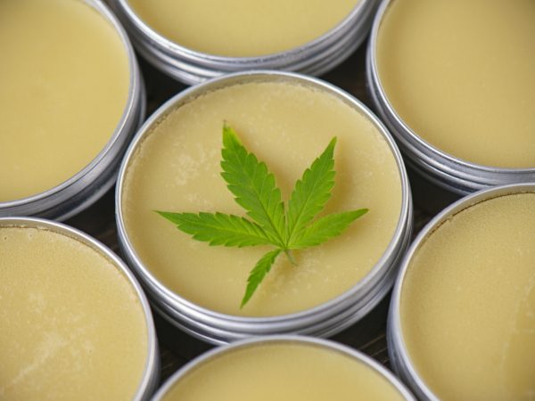 Cannabis hemp cream background with marijuana leaf - cannabis topicals concept